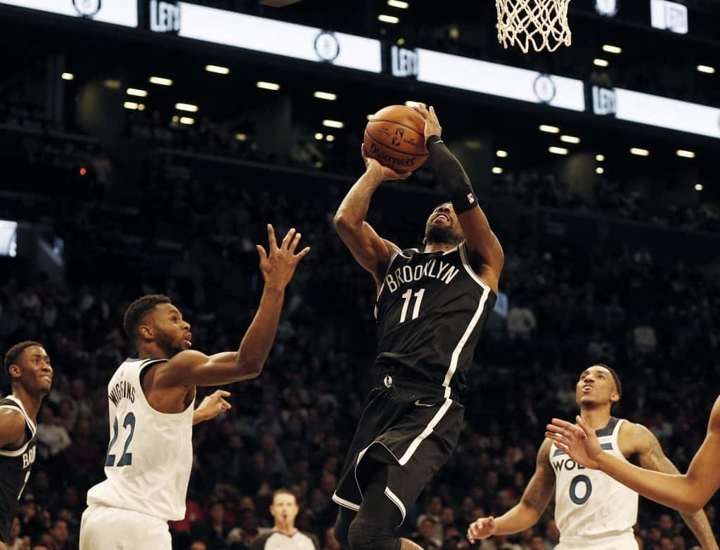 Oct 23, 2019; Brooklyn, NY, USA; Brooklyn Nets guard Kyrie Irving (11) takes a shot against Minnesota Timberwolves forward Andrew Wiggins (22) during the second half at Barclays Center. Mandatory Credit: Andy Marlin-USA TODAY Sports