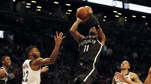 Oct 23, 2019; Brooklyn, NY, USA; Brooklyn Nets guard Kyrie Irving (11) takes a shot against Minnesota Timberwolves forward Andrew Wiggins (22) during the second half at Barclays Center. Mandatory Credit: Andy Marlin-USA TODAY Sports