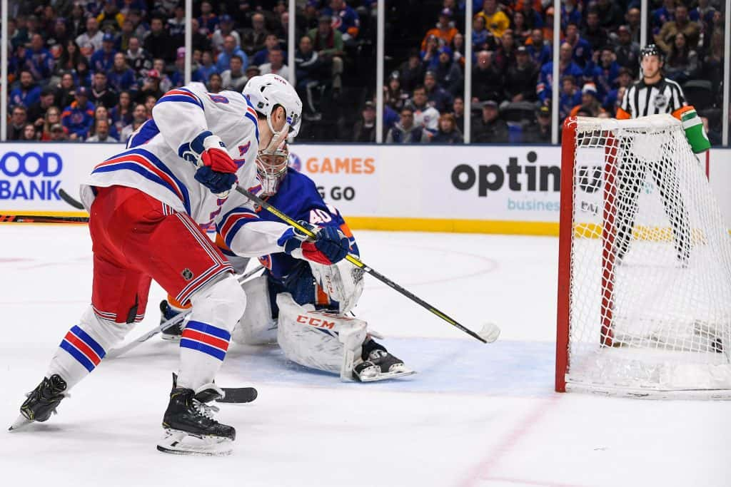 Jan 16, 2020; Uniondale, New York, USA; New York Rangers left wing Chris Kreider (20) scores the game winning goal against New York Islanders goaltender Semyon Varlamov (40) during the third period at Nassau Veterans Memorial Coliseum. Mandatory Credit: Dennis Schneidler-USA TODAY Sports