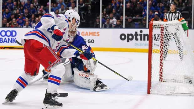 Jan 16, 2020; Uniondale, New York, USA; New York Rangers left wing Chris Kreider (20) scores the game winning goal against New York Islanders goaltender Semyon Varlamov (40) during the third period at Nassau Veterans Memorial Coliseum. Mandatory Credit: Dennis Schneidler-USA TODAY Sports