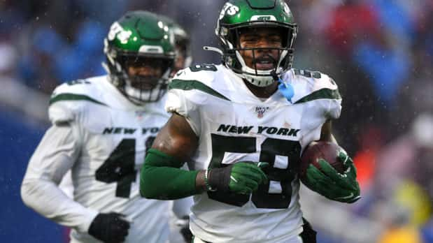 Dec 29, 2019; Orchard Park, New York, USA; New York Jets outside linebacker James Burgess (58) jogs off the field after his interception against the Buffalo Bills during the second quarter at New Era Field. Mandatory Credit: Rich Barnes-USA TODAY Sports