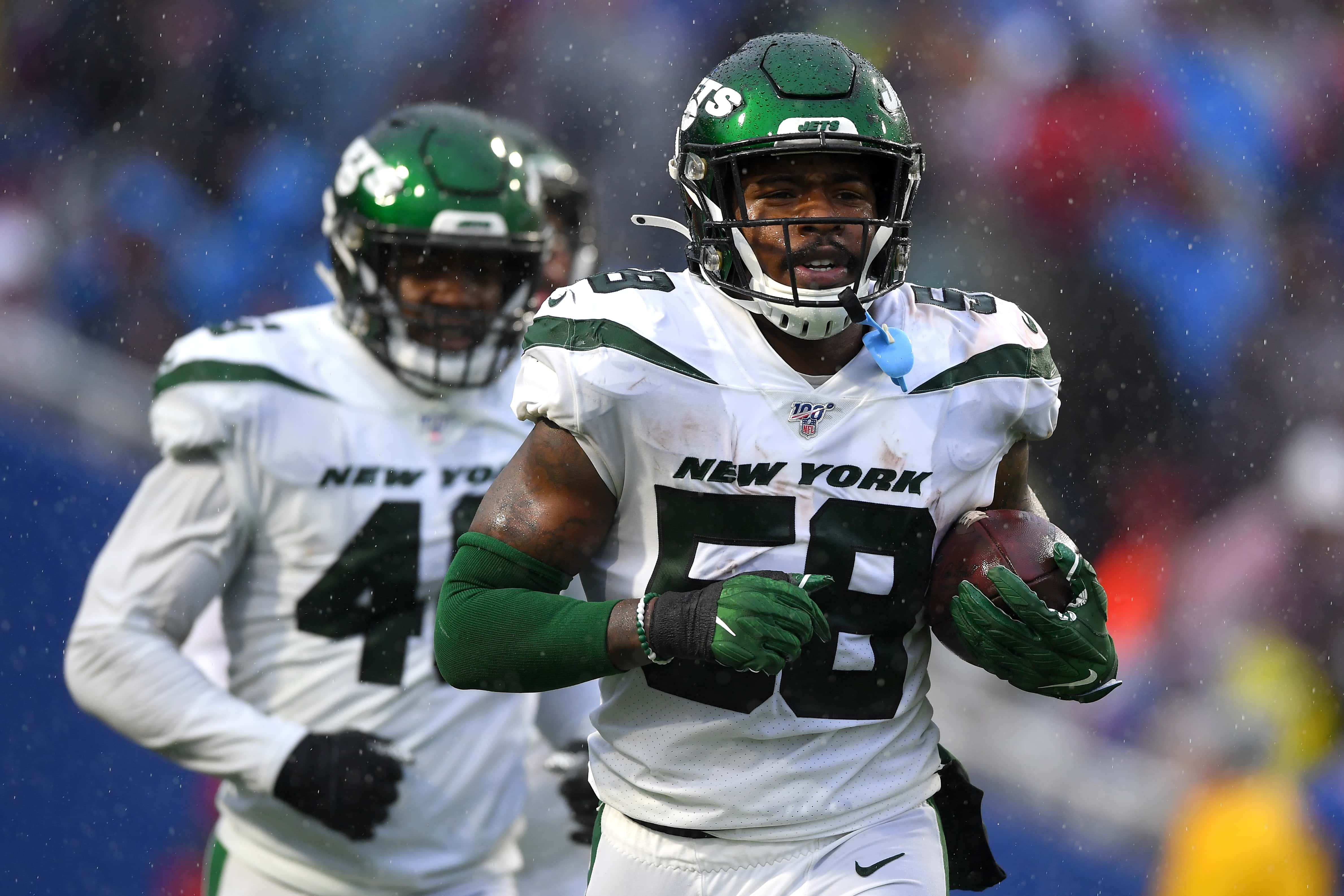 Dec 29, 2019; Orchard Park, New York, USA; New York Jets outside linebacker James Burgess (58) jogs off the field after his interception against the Buffalo Bills during the second quarter at New Era Field. Mandatory Credit: Rich Barnes-USA TODAY Sports