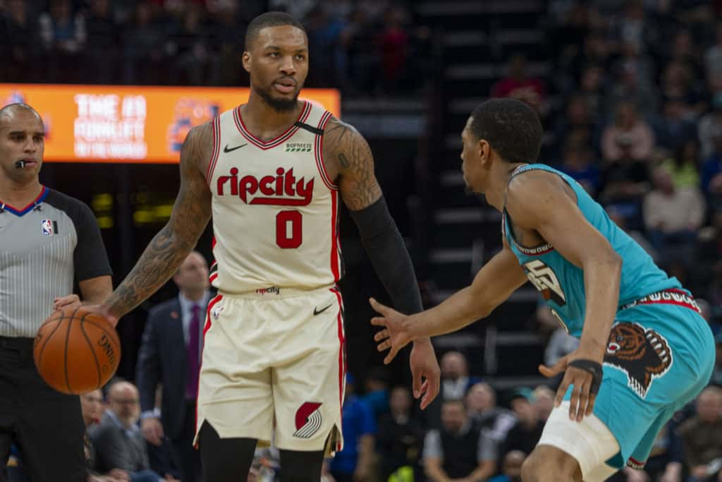 Feb 12, 2020; Memphis, Tennessee, USA; Portland Trail Blazers guard Damian Lillard (0) handles the ball against Memphis Grizzlies guard De'Anthony Melton (0) during the first half at FedExForum. Mandatory Credit: Justin Ford-USA TODAY Sports