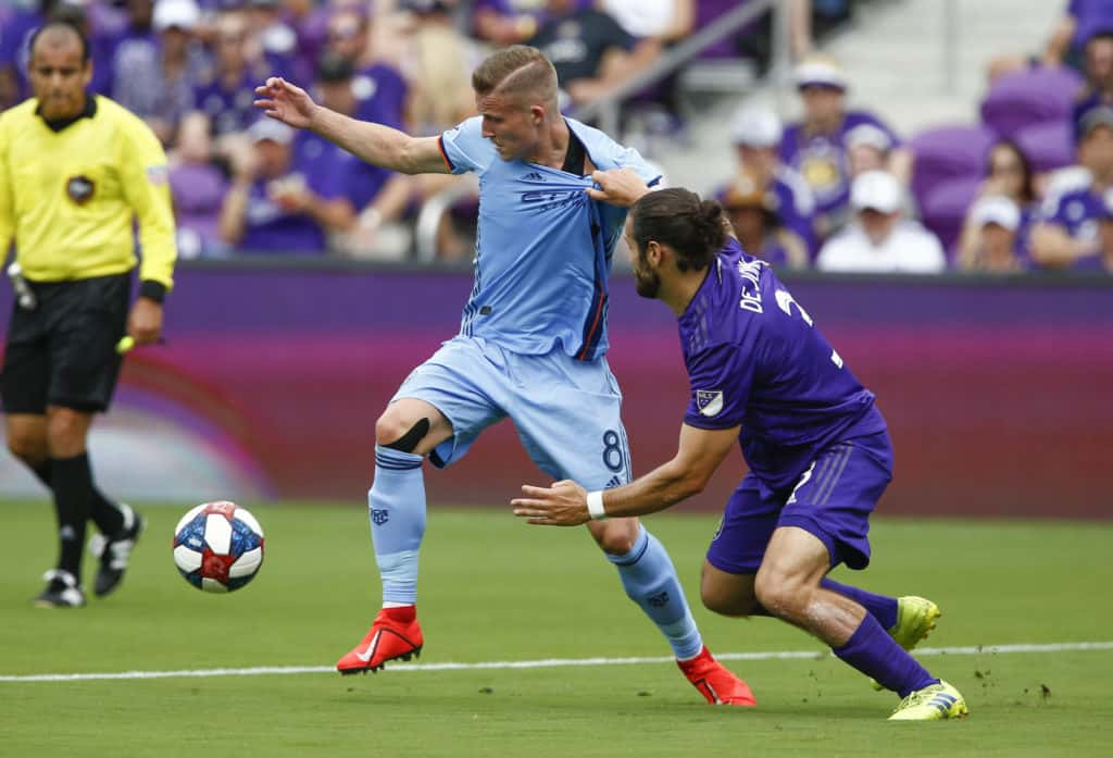 Mar 2, 2019; Orlando, FL, USA; New York City FC midfielder Alexander Ring (8) and Orlando City FC defender Alex De John (3) battle for the ball during the first half of a soccer match at Orlando City Stadium. Mandatory Credit: Reinhold Matay-USA TODAY Sports