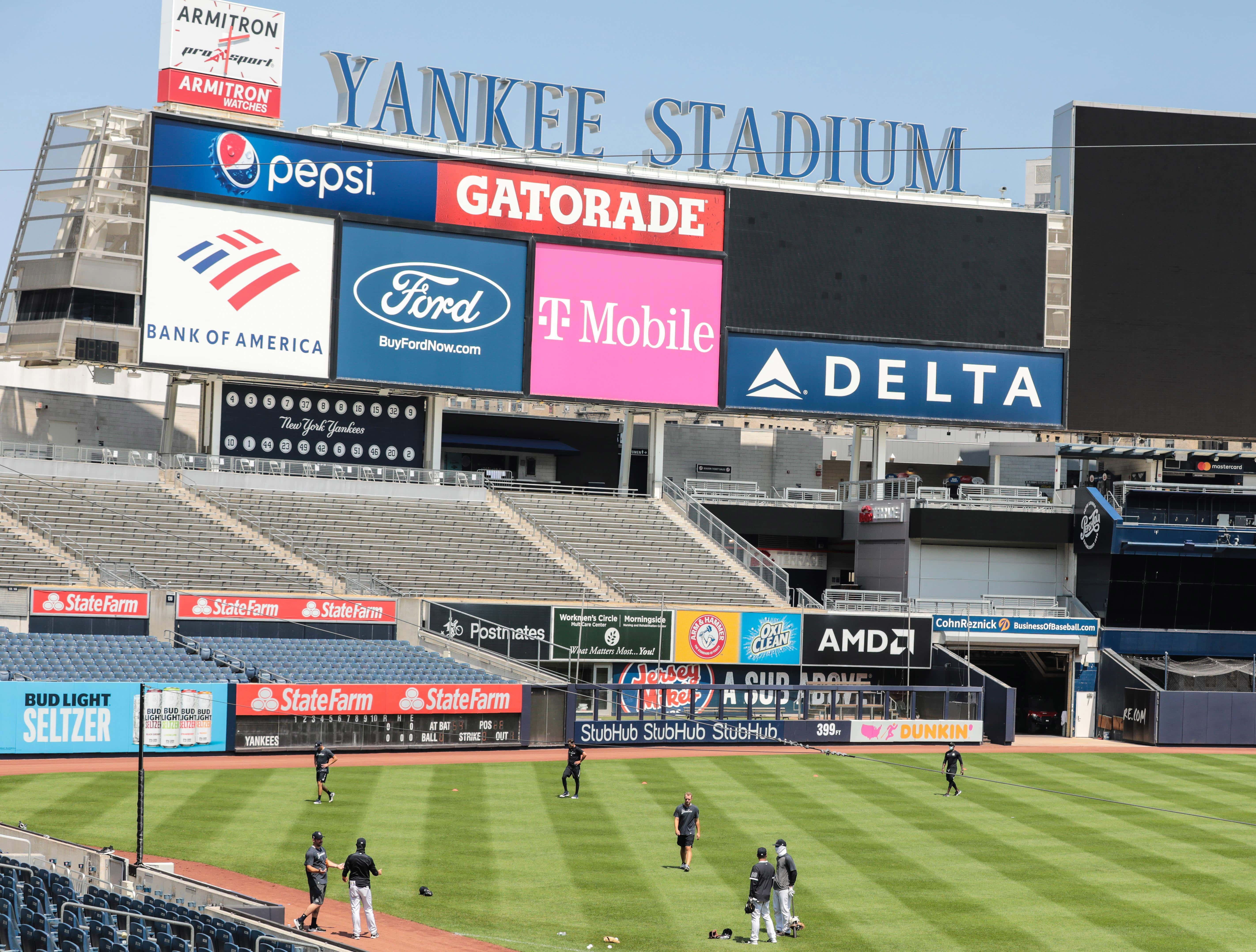 Jul 6, 2020; Bronx, New York, United States; New York Yankees players workout in left field at Yankee Stadium. Mandatory Credit: Vincent Carchietta-USA TODAY Sports