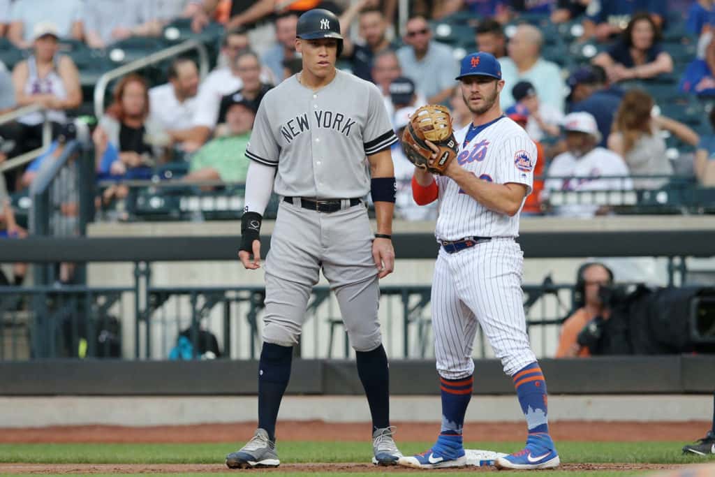 Jul 2, 2019; New York City, NY, USA; New York Yankees right fielder Aaron Judge (99) stands next to New York Mets first baseman Pete Alonso (20) at first base after drawing a walk during the first inning at Citi Field. Mandatory Credit: Brad Penner-USA TODAY Sports