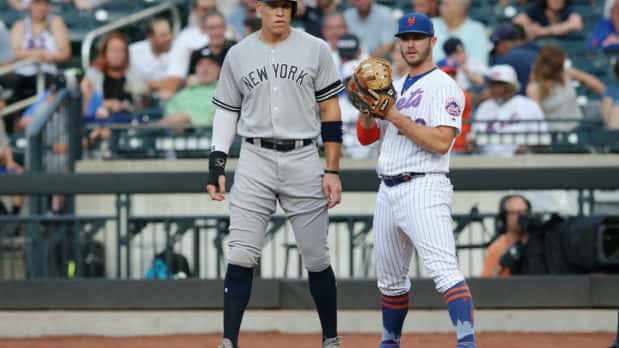 Jul 2, 2019; New York City, NY, USA; New York Yankees right fielder Aaron Judge (99) stands next to New York Mets first baseman Pete Alonso (20) at first base after drawing a walk during the first inning at Citi Field. Mandatory Credit: Brad Penner-USA TODAY Sports