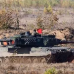Pabrade Lithuania A Leopard 2A7 main battle tank is captured in action^ firing its main cannon during a live-fire exercise. 10-13 - 2020
