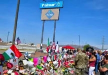 Flowers^ posters^ toys and other memorabilia left for the victims of the Walmart shooting on 3 August 2019. El Paso^ Texas / USA - August 2019