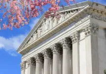 Washington D.C. US Supreme Court building. during spring time; cherry blossoms seen in front of image of Supreme Court