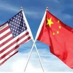 American and Chinese flags on cloudy sky. waving in the sky