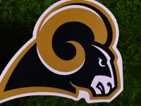 The logo of the Los Angeles Rams football club on the green lawn of the stadium.