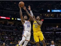 Realistic photography of two basketball players fighting in the air to catch the ball falling after a failed shot in an nba game. one basketball player is from the oklahoma city thunder and the other basketball player is from the indiana pacers. the photo