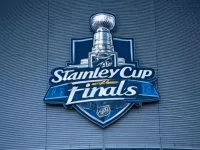 the front facade of a hockey arena with the NHL Stanley Cup Finals logo on the front of the building.