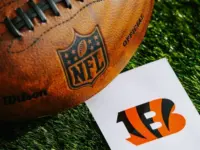 Cincinnati Bengals NFL team Logo and American football ball on Green Grass. CINCINNATI^ USA^ FEBRUARY 10^ 2025