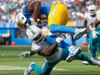 Los Angeles Chargers wide receiver Mike Williams (TOP) is brought down by Miami Dolphins cornerback Kader Kohou (BOTTOM) during an NFL football game^ Sept. 10^ 2023^ in Inglewood^ Calif.