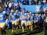 UCLA players run onto the field before an NCAA college football game between the UCLA and the Arizona State^ Nov. 11^ 2023^ in Pasadena^ Calif.
