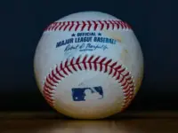 Baseball with 'Official Major League Baseball' Inscription and Blue MLB Batter Silhouette Logo