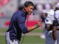 Notre Dame's Marcus Freeman congratulates his team after a score at Razorback Stadium^ Fayetteville^ AR. Sept 27^ 2025