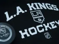 Official NHL game puck with LA kings equipment ^ product shot