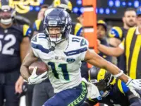 Seattle Seahawks wide receiver Jaxon Smith-Njigba (11) escapes a tackle-attempt by Los Angeles Rams cornerback Emmanuel Forbes Jr. (1) during an NFL football game Nov. 16^ 2025^ in Inglewood^ Calif.