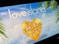'2025 Love Island'' shown on a smart phone. is a reality dating show that originated in the UK. The premise involves a group of singles living together in a luxurious villa^ where they couple up Toronto^ Canada - June 5
