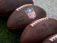 NLF footballs are displayed before an NFL football game between the Los Angeles Rams and the Seattle Seahawks at SoFi Stadium Sunday Nov. 16^ 2025^ in Inglewood^ Calif.