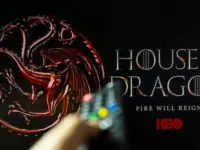 House of the Dragon HBO TV series on TV with remote control in hand. Focuse on the tv screen. Story takes place 300 years before events portrayed in Game of Thrones