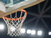 Basketball hoop hanging in a sports stadium waiting for the ball