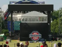 WASHINGTON^ DC - June 7^ 2026: Tourists look on the Ultimate Fighting Championship's octagon set up on the White House South Lawn for an event scheduled for June 14.