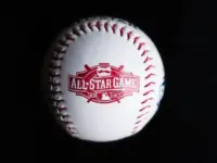 Close up baseball printed with logo for the 2015 Major League Baseball All-Star Game isolated on a dark black background. Cincinnati^ Ohio^ USA - July 21 2022