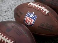 NLF footballs are displayed before an NFL football game between the Los Angeles Rams and the Seattle Seahawks at SoFi Stadium Sunday Nov. 16^ 2025^ in Inglewood^ Calif.