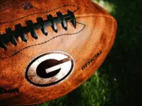 Green Bay Packers or Georgia Bulldogs NFL football Team Logo on the leather of American Football Ball