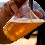 canva-person-pouring-beer-on-clear-cup