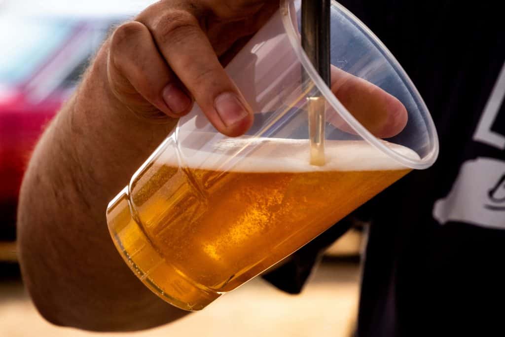 canva-person-pouring-beer-on-clear-cup-jpg-2