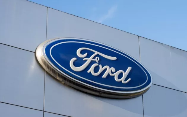 Closeup of the Ford logo seen at a Ford dealership store in Sunnyvale^ California. Ford Motor Company is an American multinational automobile manufacturer. Sunnyvale^ CA^ USA - Nov 22^ 2023