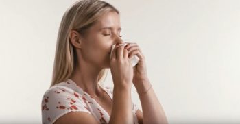 woman blowing nose vaev tissue