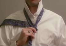 man tying neck tie