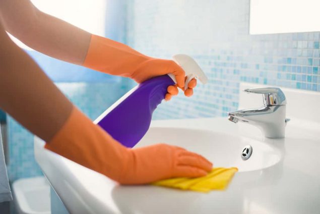 woman cleaning sink