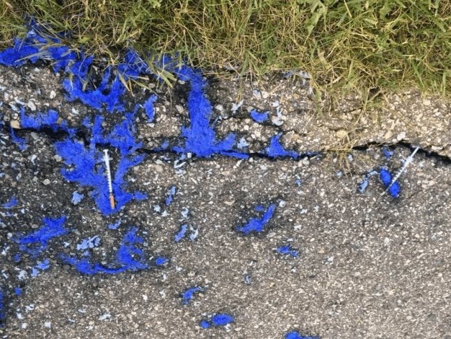 needles and blue waste on pavement