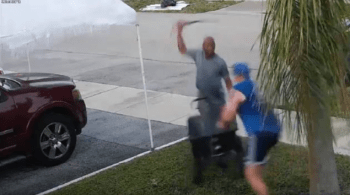 man swings sword after another man fighting over utility cart
