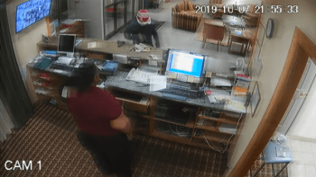 surveillance footage of a bank robbery where robber leaves gun on counter