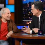 m_paulsimomcolbert_040326157586